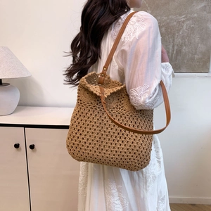 Hollow cotton rope woven tote bag with brown leather straps for beach vacation style