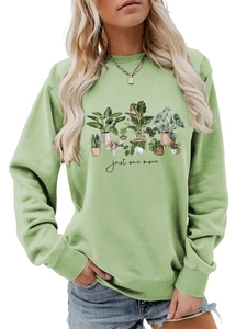Detail of light green crewneck sweatshirt with potted plants print and ribbed cuffs