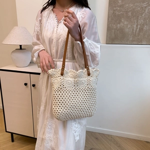 Hollow crochet tote bag with sunflower details and leather handles for summer beach