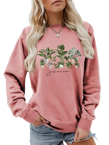 Detail of soft pink sweatshirt showing rib-knit cuffs and botanical plant print