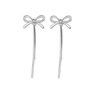 Élégantes boucles d'oreilles nœud argentées avec de longues franges sur fond blanc