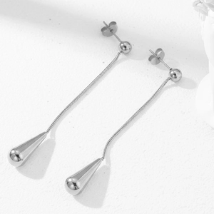 Minimalist silver stainless steel teardrop tassel earrings on white stone background