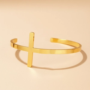 Detailed view of the 18K gold plated cross cuff bracelet with a flat polished finish