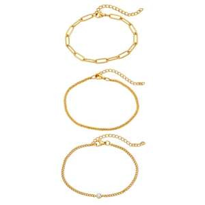 Set of three golden stainless steel paperclip and curb bracelets with zircon detail
