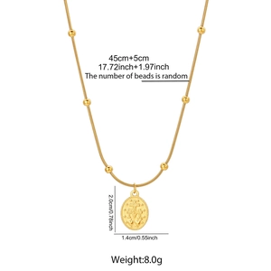 Detailed macro view of 18K gold plated oval pendant with religious cross and star motifs