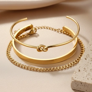 Three-piece gold stainless steel jewelry set featuring knot bangle and Cuban chain
