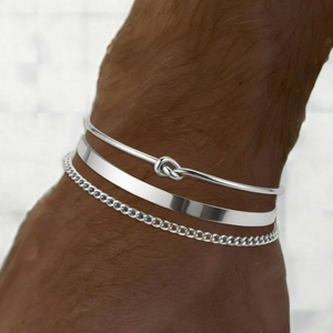 Three-piece stainless steel bracelet set featuring knot design, flat cuff, and Cuban chain