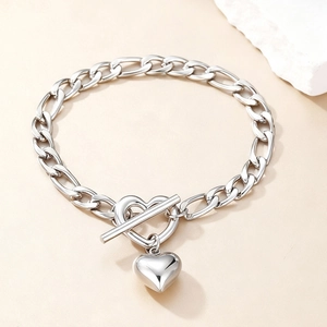 Polished stainless steel heart pendant bracelet with unique toggle clasp on warm background