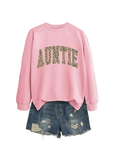 Mise à plat de sweat rose avec texte AUNTIE léopard et short en jean vieilli bleu