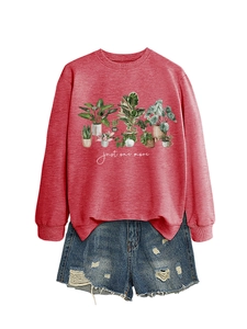 Detailed flat lay of red crewneck sweatshirt with botanical print and denim shorts