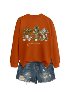 Detail of caramel crewneck sweatshirt with potted plants print and blue denim shorts