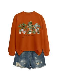 Detail of caramel crewneck sweatshirt featuring potted plant graphics and text