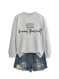 Flat lay of gray booktrovert sweatshirt paired with distressed denim shorts on white background