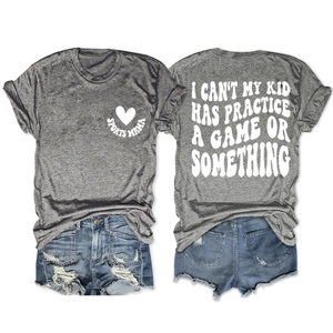 Macro view of gray cotton t-shirt with I Can't My Kid Has Practice slogan and denim shorts