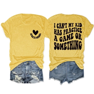 Detail of Sports Mama slogan print on mustard yellow cotton t-shirt with denim shorts