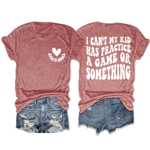 Detailed flat lay of red cotton blend t-shirt with Sports Mama print and denim shorts