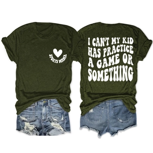 Detail view showing distressed denim shorts paired with a green Sports Mama graphic tee