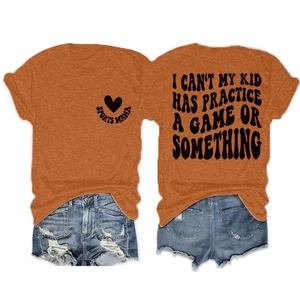 Detail of orange sports mama graphic t-shirt with back text and distressed denim shorts