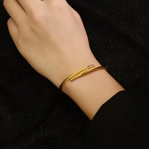 Modern gold-plated stainless steel wire wrap cuff bracelet with screw-end detail for women