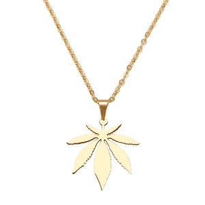 Close-up of golden stainless steel maple leaf pendant on a delicate chain necklace
