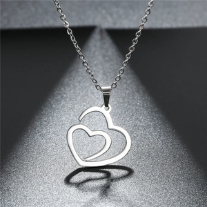 Macro detail of polished stainless steel hollow double heart pendant necklace