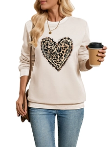Detail shot of the heart leopard print on the cream white long sleeve sweatshirt