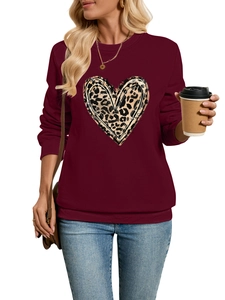 Detail of burgundy sweatshirt with leopard heart print and textured raw edges