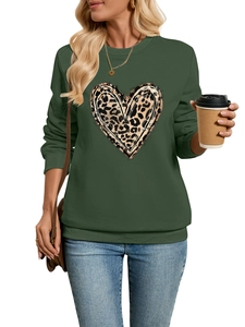 Close-up of leopard heart print on dark green plush sweatshirt with a stylish casual look
