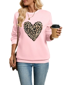 Close-up of pink leopard heart print on cozy plush sweatshirt with ribbed cuffs