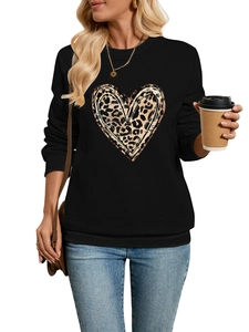 Detail shot of black sweatshirt featuring a leopard print heart motif and ribbed crewneck