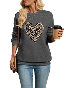 Detail of grey sweatshirt showing leopard heart print and soft plush fabric texture