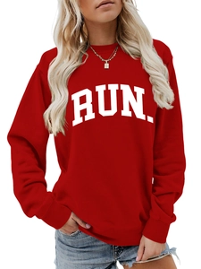 Close-up of RUN print on red crewneck sweatshirt with ribbed cuffs and soft fabric