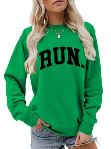 Close-up of RUN print on green crew neck sweatshirt with ribbed neckline detail