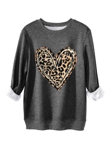 Detail of grey sweatshirt showing warm white fleece lining and leopard heart print