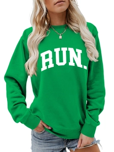 Detail of emerald green sweatshirt showing white RUN print and ribbed sleeve cuffs