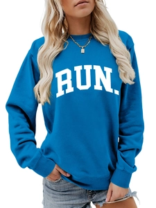 Close-up of royal blue crewneck sweatshirt with white RUN block letters and ribbed cuffs