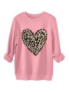 Detail of pink sweatshirt featuring leopard print heart and ribbed knit cuffs