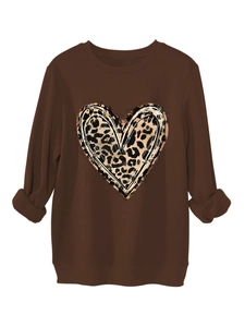 Detail of leopard print heart graphic with ink splash effect on brown plush sweatshirt