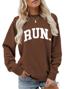 Close-up of ribbed cuffs and RUN letter print on a brown oversized sports sweatshirt