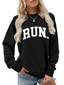 Detail shot of black sweatshirt with bold RUN letter print and soft cotton texture