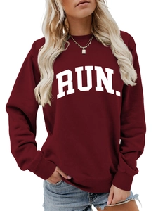 Close-up of burgundy crew neck sweatshirt with white RUN text and ribbed cuffs