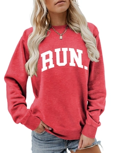 Close-up of red crewneck sweatshirt featuring a bold white RUN. print and soft cotton texture