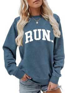 Detail of blue crewneck sweatshirt with bold white RUN print and ribbed texture