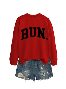 Detail of red crewneck sweatshirt with black RUN lettering and frayed denim shorts