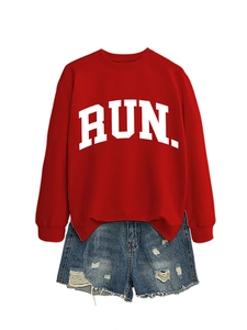 Detail of red RUN letter print sweatshirt and distressed denim shorts street style outfit