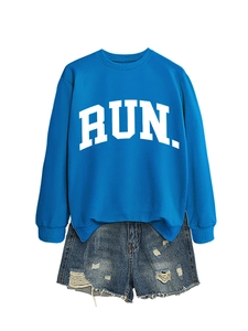 Detail of royal blue sweatshirt with white RUN print and distressed denim shorts