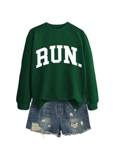 Detail of dark green sweatshirt with white RUN letters and distressed denim shorts