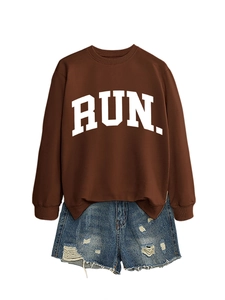 Detailed flat lay of a brown RUN sweatshirt paired with distressed denim shorts