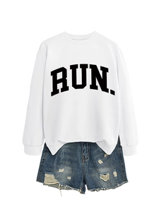 Detail of white crewneck sweatshirt with RUN lettering and distressed denim shorts