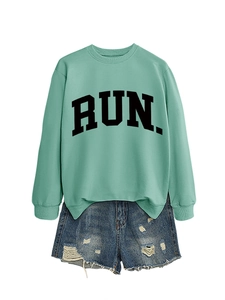 Close-up of mint green RUN sweatshirt with rib-knit cuffs and distressed denim shorts